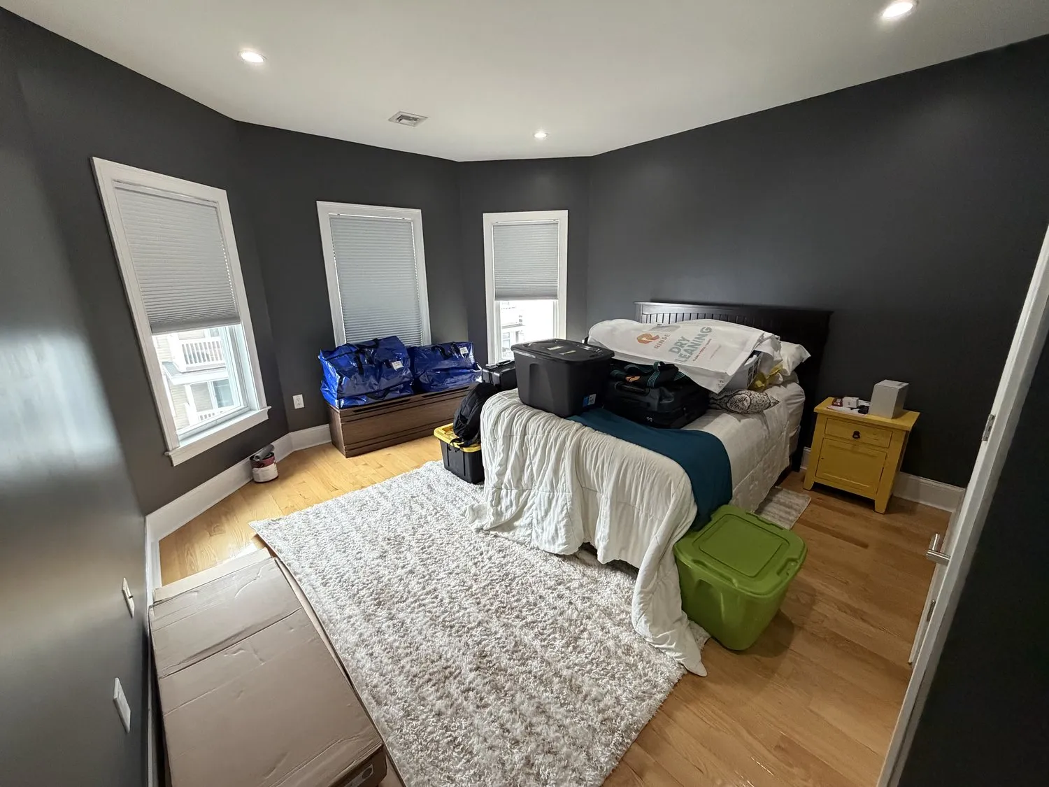 A Dorchester bedroom in deep navy with white trim and a pale rug